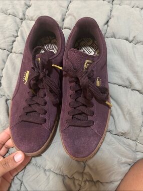 Puma suede low-top sneakers in burgundy with gold accents